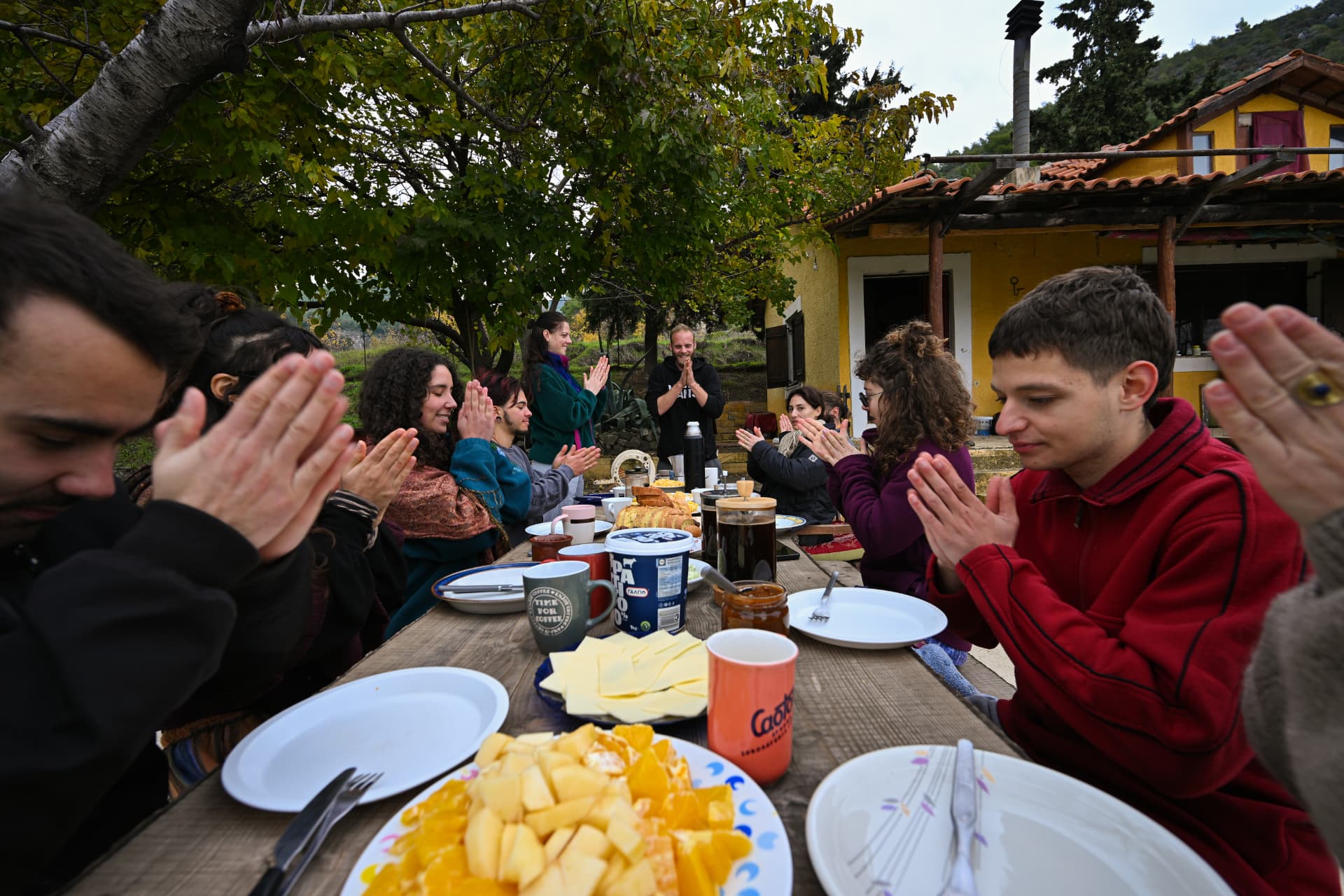Long communal breakfast table under the trees